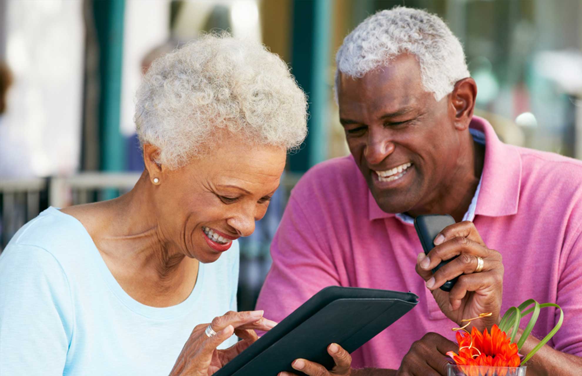 An elderly person using a tablet to access digital government services — AI-powered voice interaction, plain language translation and patient guidance make digital services genuinely accessible to older users